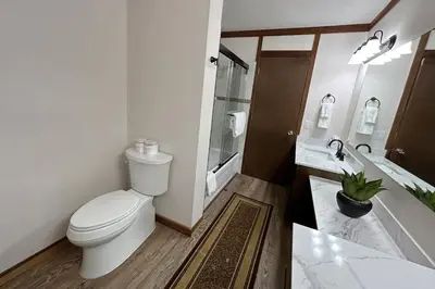 a bathroom with a toilet and a tub and a sink at Brookstone Pines home in Incline Village