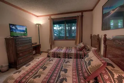 a bedroom with two beds and a television in it at Brookstone Pines home in Incline Village