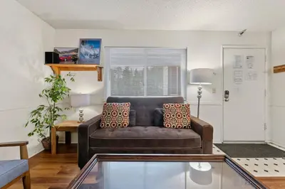 a living room with a leather couch and a table at Heavenly Chairview Condo home in Stateline