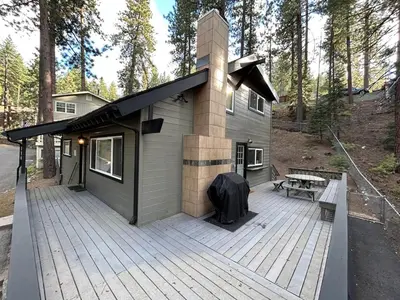 a house with a large deck with a building at Foothill Folly home in Zephyr Cove