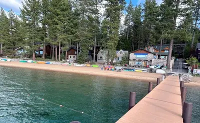 a pier with a beach with houses and a shoreline at Smokey Joes cabin in Zephyr Cove