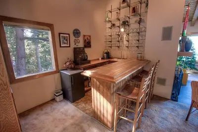 a kitchen with a large wooden bar in a room at Lake View Glen home in Lincoln Park