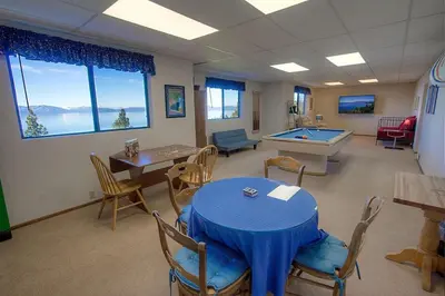a waiting room with a table and ping pong ball at Lake View Glen home in Lincoln Park