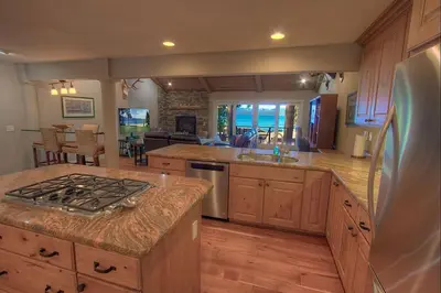 a large kitchen with a stove and a refrigerator at Chipmunk's Paradise condo in Kings Beach