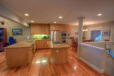 a large kitchen with wooden floors and a counter top at Chipmunk's Paradise condo in Kings Beach
