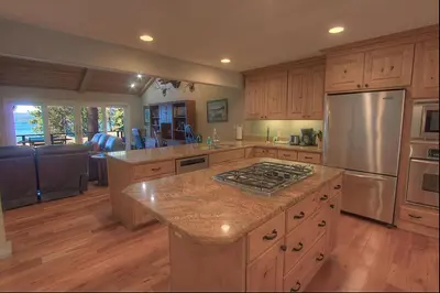 a large kitchen with wooden cabinets and a refrigerator at Chipmunk's Paradise condo in Kings Beach