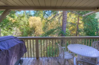 a porch with a table and chairs on a deck at Forest View Townhouse home in Kings Beach