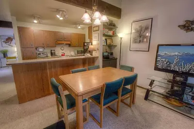 a kitchen and dining room with a wooden table and chairs at Forest View Townhouse home in Kings Beach