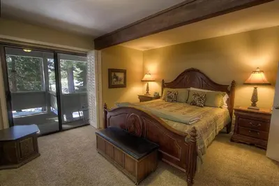 a bedroom with a large bed and a window at Eagle's Lake Retreat condo in Incline Village