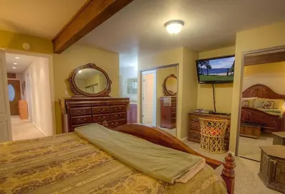 a bedroom with a bed and a flat screen tv at Eagle's Lake Retreat condo in Incline Village