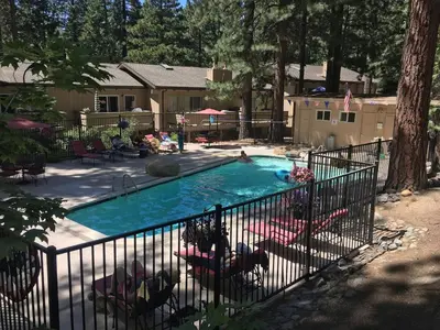a swimming pool in a yard with a fence at Eagle's Lake Retreat condo in Incline Village