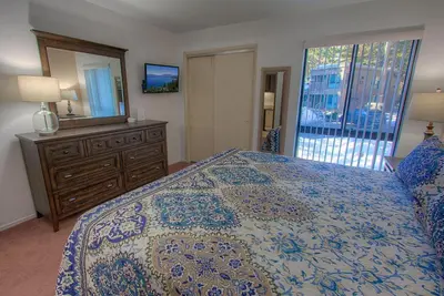 a bedroom with a bed and a dresser and a mirror at Sparrow's Nest home in Incline Village
