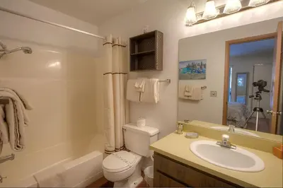 a bathroom with a sink and a toilet and a mirror at Sparrow's Nest home in Incline Village