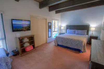 a bedroom with a bed and a flat screen tv at Sparrow's Nest home in Incline Village