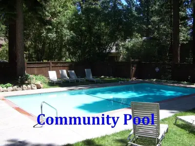 a swimming pool with two lawn chairs and a swimming pool at Sparrow's Nest home in Incline Village