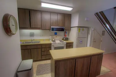 a kitchen with wooden cabinets and a white refrigerator at Sparrow's Nest home in Incline Village