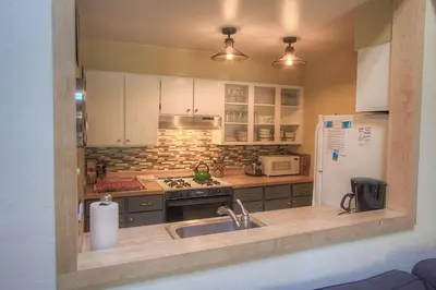 a kitchen with a sink and a refrigerator at Alpine Getaway home in Tahoe City