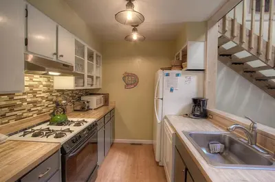 a kitchen with a sink and a refrigerator at Alpine Getaway home in Tahoe City