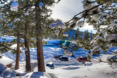 a parking lot covered in snow with cars parked at Tahoe Olympic condo in Stateline