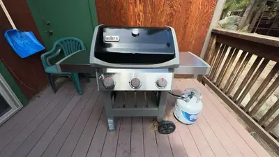 a grill sitting on a deck with a chair at Tahoe Olympic condo in Stateline