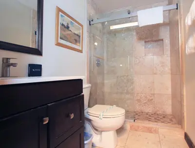 a bathroom with a toilet and a glass shower at Tahoe Olympic condo in Stateline