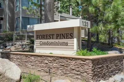 a sign for a forest pines apartment building at Tall Pines Retreat condo in Incline Village