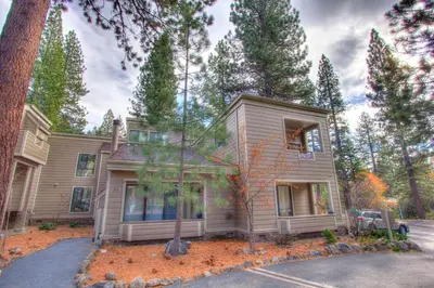 a house with a car parked in front of it at Tall Pines Retreat condo in Incline Village
