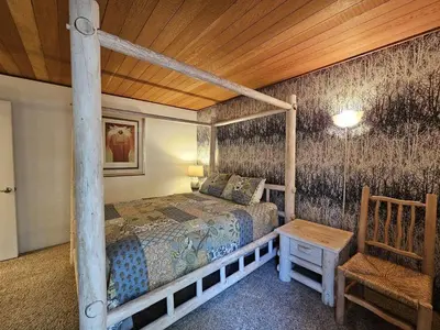 a bedroom with a bed and a wooden ceiling at Tall Pines Retreat condo in Incline Village