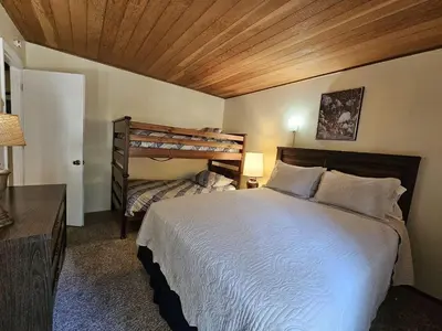 a bedroom with a bed and a bunk bed at Tall Pines Retreat condo in Incline Village