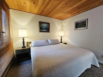 a bedroom with a white bed and two lamps at Cartwright Corner Condo townhouse in Incline Village