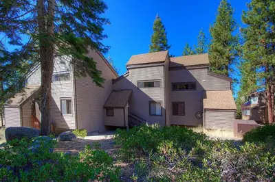 a large house with trees in front of it at Chimney Rock Condo condo in Stateline