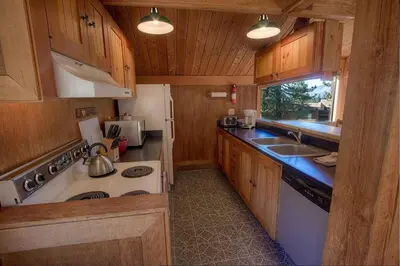 a kitchen with wooden cabinets and a stove and sink at Chimney Rock Condo condo in Stateline