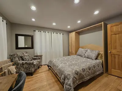 a bedroom with a bed and a chair at Gale Force Wind home in Incline Village