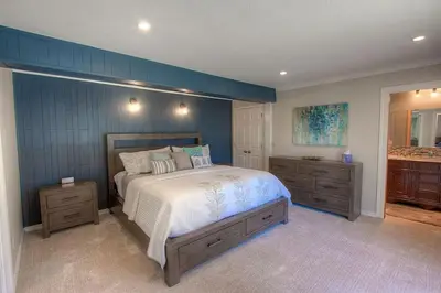 a bedroom with a large bed and a bathroom at Gale Force Wind home in Incline Village