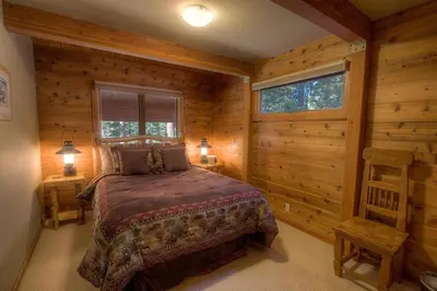 a bedroom with a bed in a log cabin at The Bass Chalet home in Kings Beach