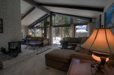 a living room with a couch and a fireplace at Blue Laulea home in Incline Village