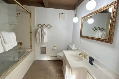 a bathroom with a sink and a toilet and a mirror at Tumbleweed Pines home in Incline Village