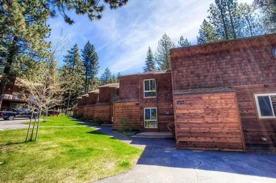 a large wooden house with a grass yard at Brockway Beachside Bungalo home in Kings Beach