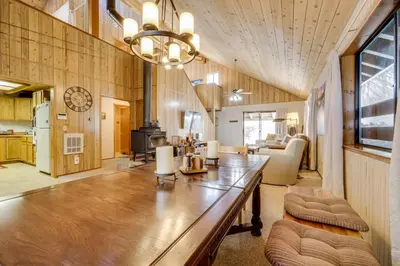 a living room with a large wooden table in a room at 6 Mi to Sugar Bowl Resort Soda Springs Cabin! in Soda Springs