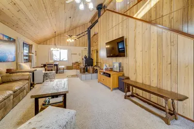 a living room with a couch and a tv at 6 Mi to Sugar Bowl Resort Soda Springs Cabin! in Soda Springs