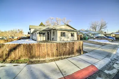 a house with a wooden fence in front of it at Gateway to Mt Rose Ski! Reno Home with Fireplace in Reno