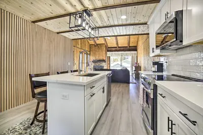a kitchen with white cabinets and a counter top at 1 Mi to Lake Tahoe Vacation Rental Home! in Stateline
