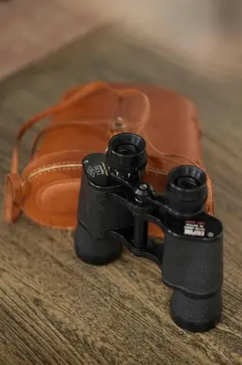 a pair of binoculars sitting on top of a purse at NEW Upscale House, Tahoe 30-min w/ Cal King in Steamboat