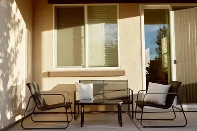 a patio with two chairs and a table and a window at NEW Upscale House, Tahoe 30-min w/ Cal King in Steamboat