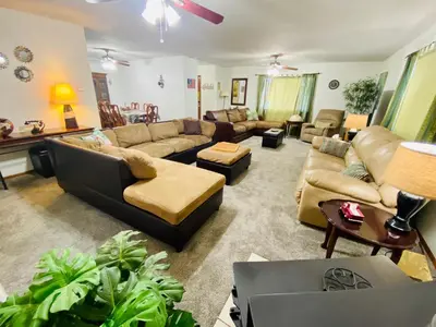 a large living room with couches and a tv at Family friendly, 3 bedroom house, with king bed for up to 15 - BBQ - Internet - jet tub in Auburn