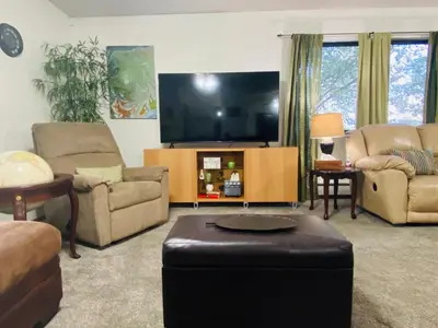 a living room with a flat screen tv and furniture at Family friendly, 3 bedroom house, with king bed for up to 15 - BBQ - Internet - jet tub in Auburn