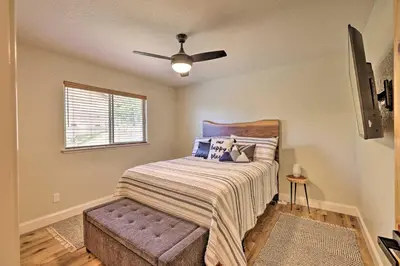 a bedroom with a bed and a ceiling fan at Near Hiking and Wineries Arnold Cabin with Deck! in Arnold