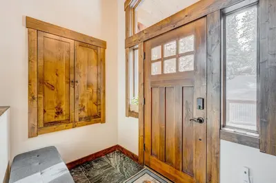 a room with a wooden door and a window at Windsor Lodge in Truckee