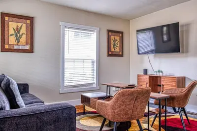 a living room with a couch and chairs and a table at 4BR Victorian Walk to UC Davis & Shriner Med Cen in Sacramento