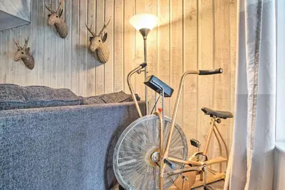 a room with a fan and a bike next to a bed at Mammoth Lakes Condo with Pool and Spa Access! in Mammoth Lakes